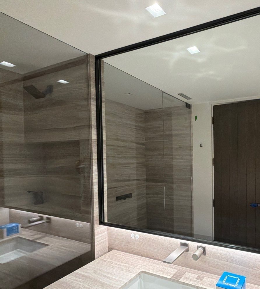 Frameless mirror over a stone vanity, a 2026 Sun Valley job