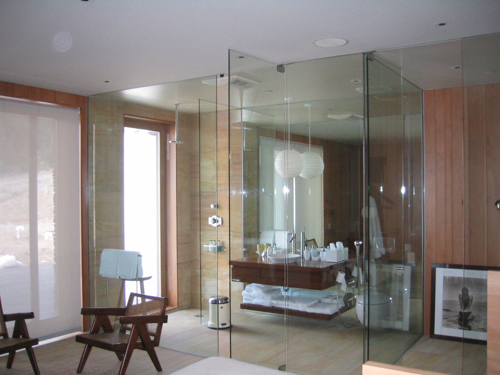 Frameless glass shower enclosure in a contemporary bath