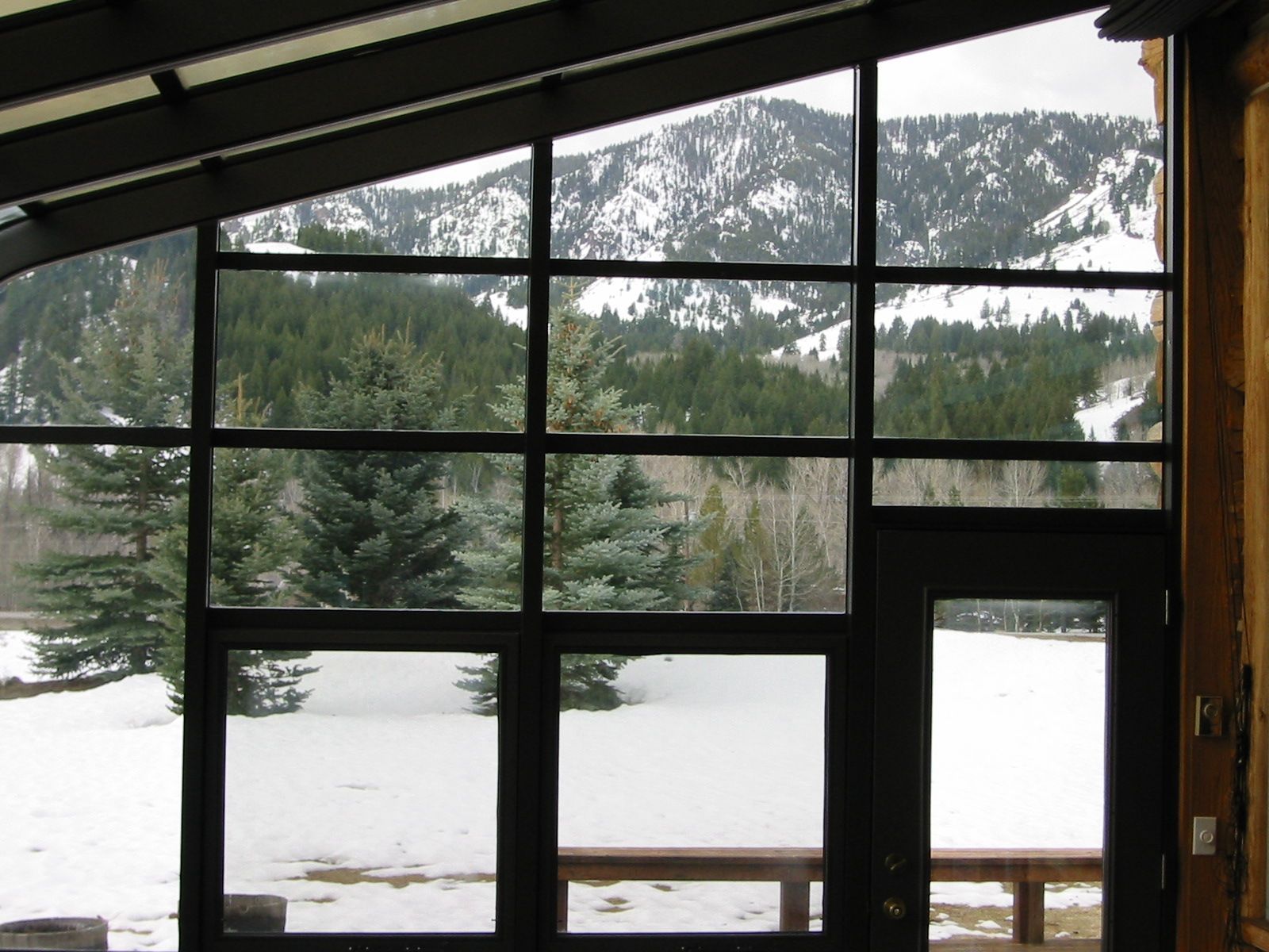 Kolbe window wall looking out to snow and pines